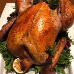 This Thanksgiving turkey is presented in the traditional style, with golden-brown skin and garnished with fresh herbs.
