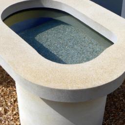 This contemporary solid form decorative concrete water feature has a textured surface that adds a unique touch to the outdoor space.