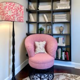 This reading nook is the perfect spot to curl up with a book, featuring a female form accent chair and bookshelf.