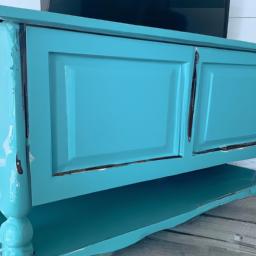 This farmhouse TV stand brings a touch of the beach to any room with its distressed blue finish and coastal design.