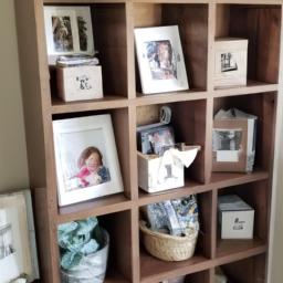 A sentimental cube shelf display featuring family photos and personalized decor items.