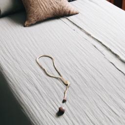 A simple wooden bead chandelier can make a big statement in a minimalist bedroom.