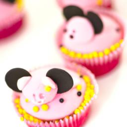 Minnie Mouse shaped cupcakes with pink frosting and sprinkles.