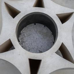 This modern solid form decorative concrete fire pit features a geometric design that adds a touch of sophistication to any outdoor living space.