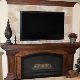 A classic and elegant mantel with a large TV as its centerpiece.